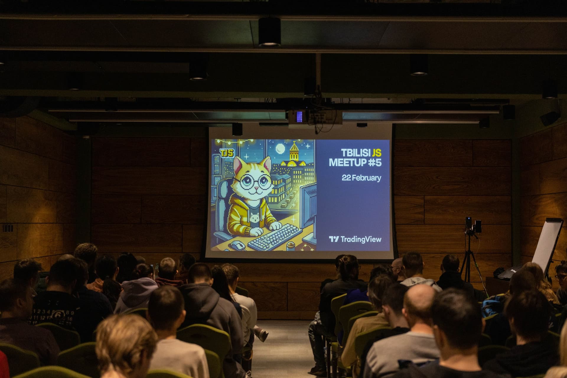 Audience attending a presentation with slides