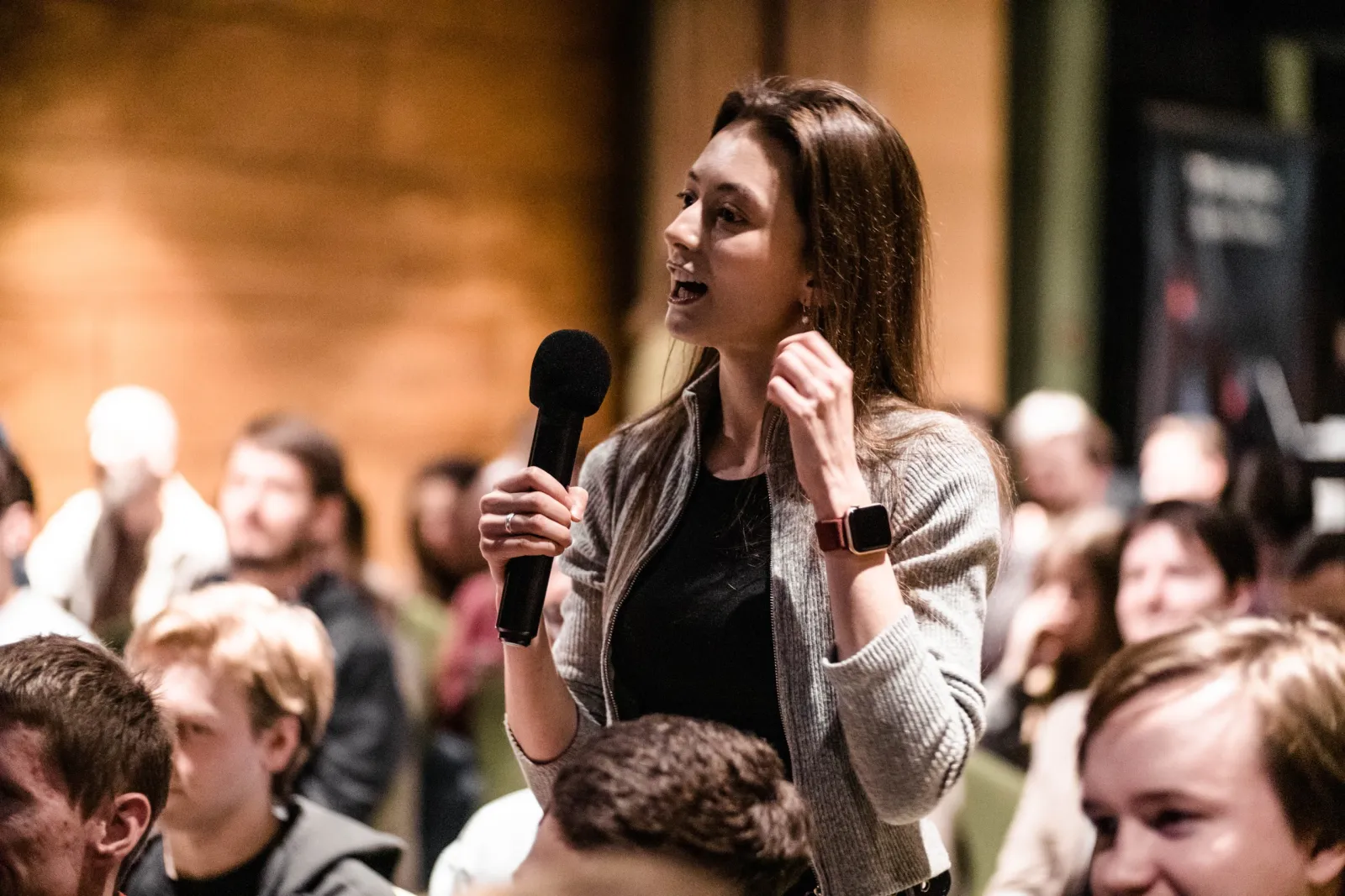 Woman speaking with a microphone at a community event